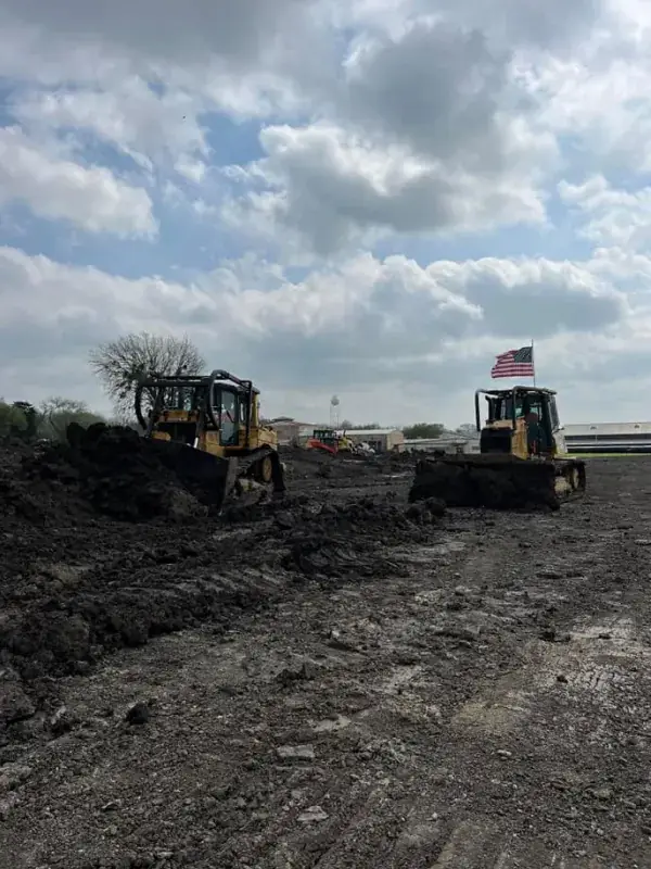 Two dozers pushing dirt