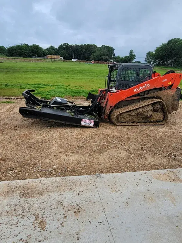 Track loader with mulcher head